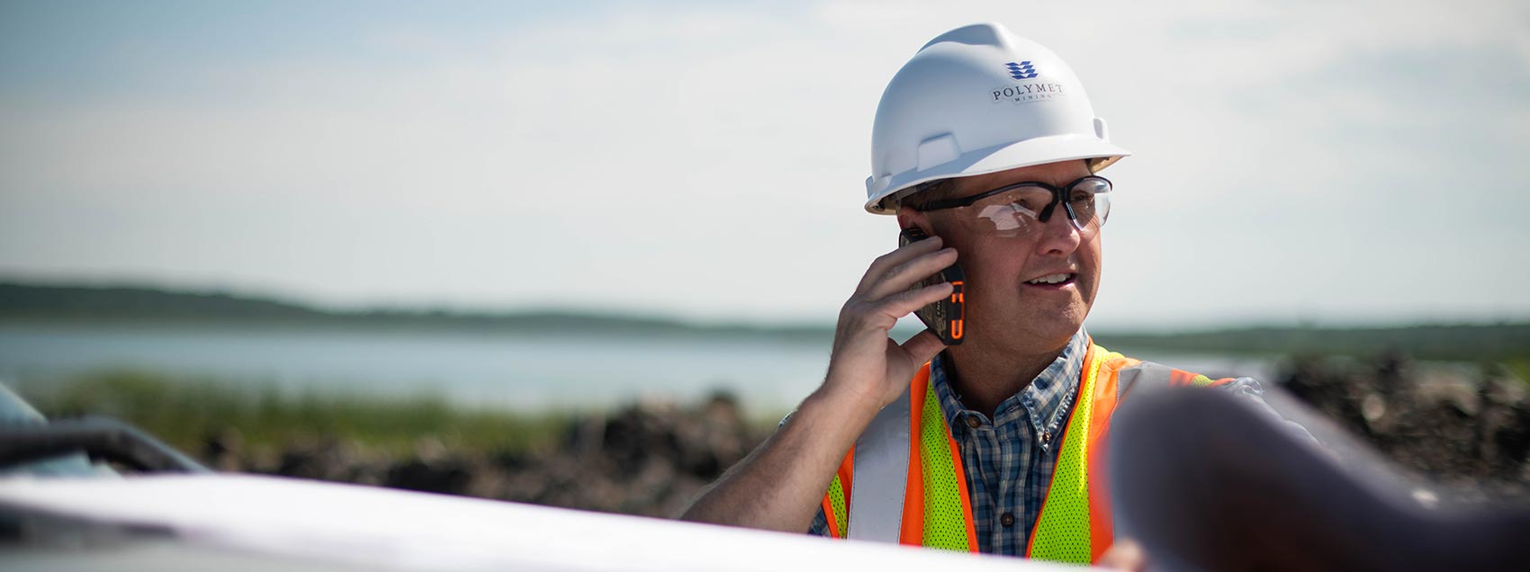 Man in hard hat talking on cell phone